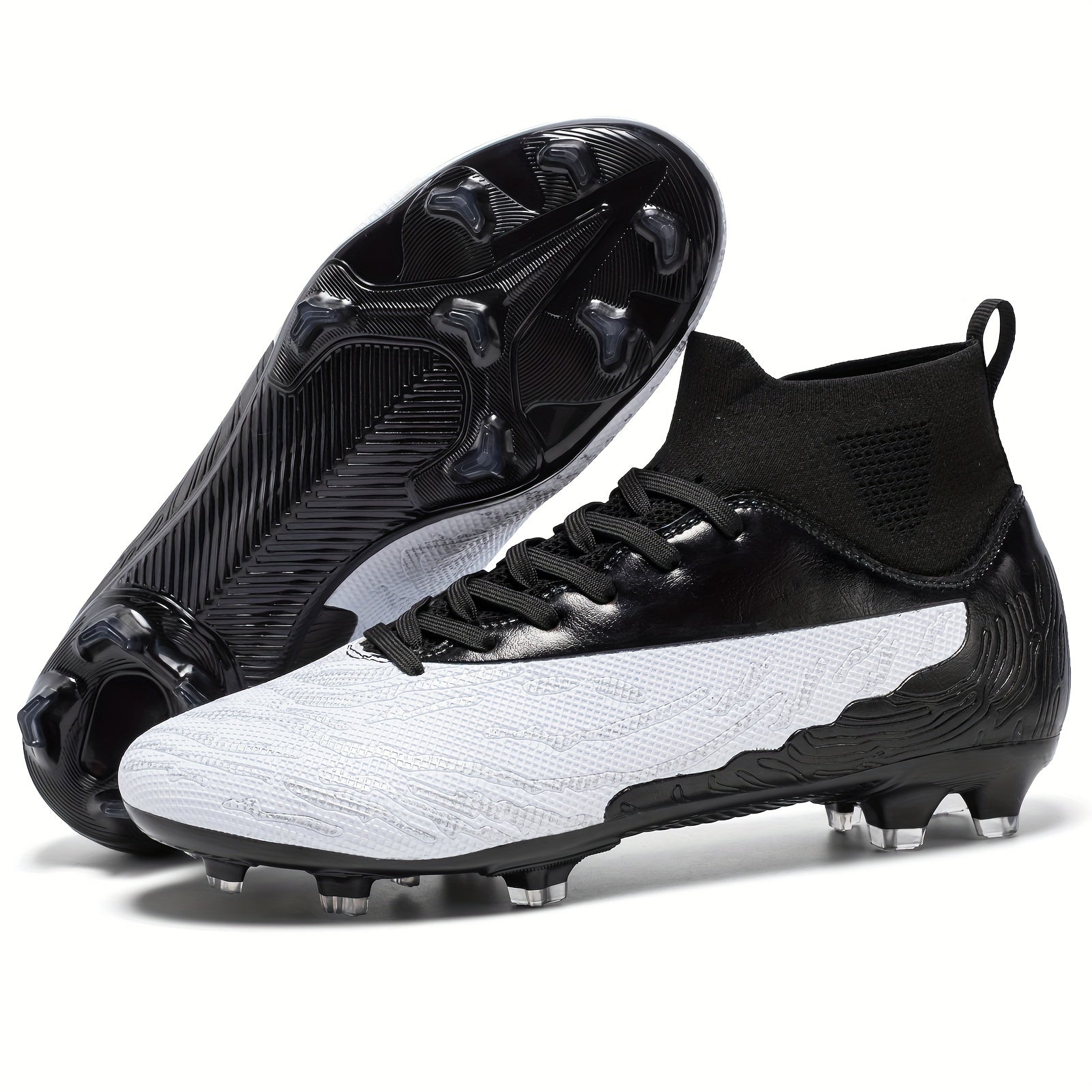 Schwarz-weiße Fußballschuhe mit Stollen, modernes Design, ideal für Rasenplätze. Perfekt für Fußballspieler, die Komfort und Stil suchen.