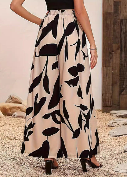 Damenhose mit weitem Bein, beige mit schwarzem Blattmuster, elastischer Bund, modisch, elegant, ideal für Sommermode und Freizeitkleidung.