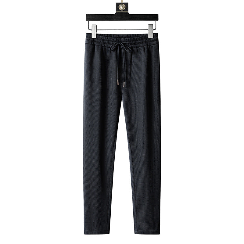 Schwarze Jogginghose aus Baumwolle mit Kordelzug, elastischem Bund und geradem Schnitt, ideal für Sport und Freizeit.