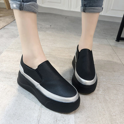 Schwarze Damen-Slip-On-Sneaker mit silbernen Akzenten und Plateau-Sohle auf grauem Fliesenboden. Bequeme Freizeitschuhe für den Alltag.