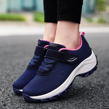 Damen-Sneaker in Blau mit rosa Akzenten, atmungsaktivem Mesh-Obermaterial und Klettverschluss, ideal für Laufen und Freizeit.
