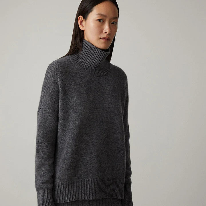 Frau in grauem Rollkragenpullover, minimalistisches Design, Herbstmode, gemütlicher Strick, eleganter Look, zeitloser Stil, Damenbekleidung.
