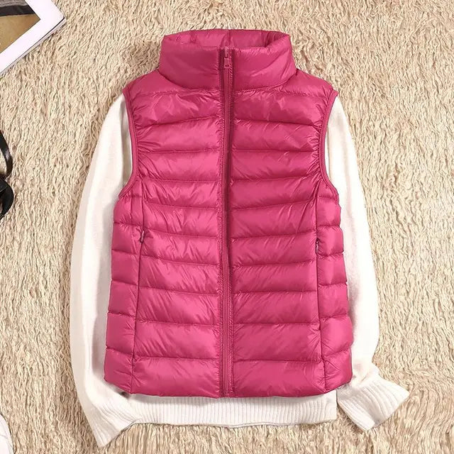 Rosa Steppweste auf cremefarbenem Pullover, modische Damenbekleidung, Herbstmode, warme Daunenweste, stilvoll und bequem.