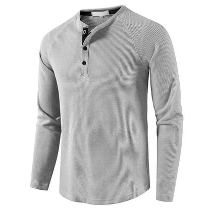 Graues Herren-Henley-Shirt mit langen Ärmeln und Knopfleiste, aus Baumwollmischung. Ideal für Freizeitmode und lässige Outfits.