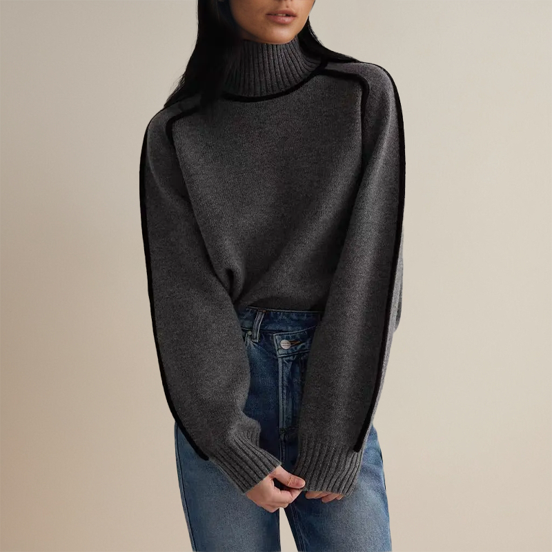 Frau in grauem Rollkragenpullover und blauer Jeans, modischer Herbstlook, gemütlicher Strick, lässiger Stil, minimalistische Mode.