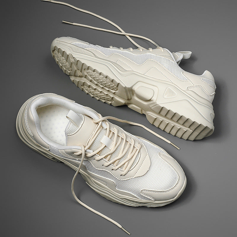 Beige Sneaker auf grauem Hintergrund, moderne Sportschuhe mit dicker Sohle, modisches Design, Herren- und Damenmode, bequeme Freizeitschuhe.
