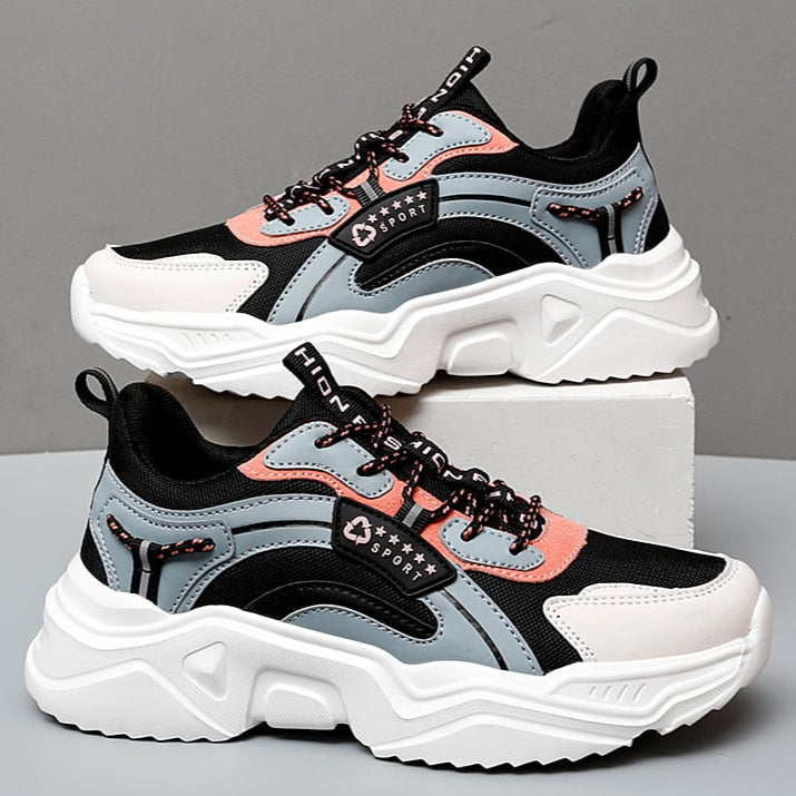 Graue und rosa Damen-Sneaker mit dicker weißer Sohle, sportliches Design, ideal für Freizeit und Fitness, modische Turnschuhe für Damen.