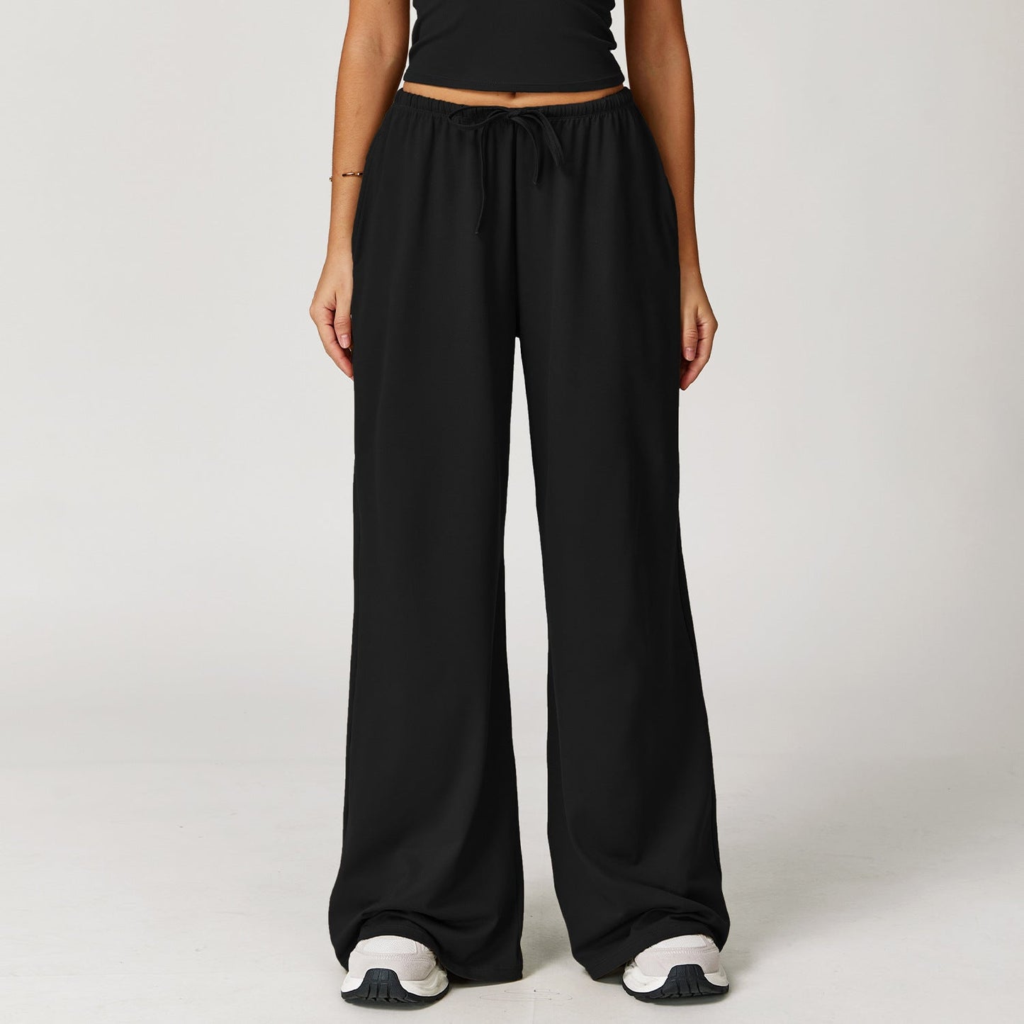Wide women's pants made of brushed leather with high waist and pendant