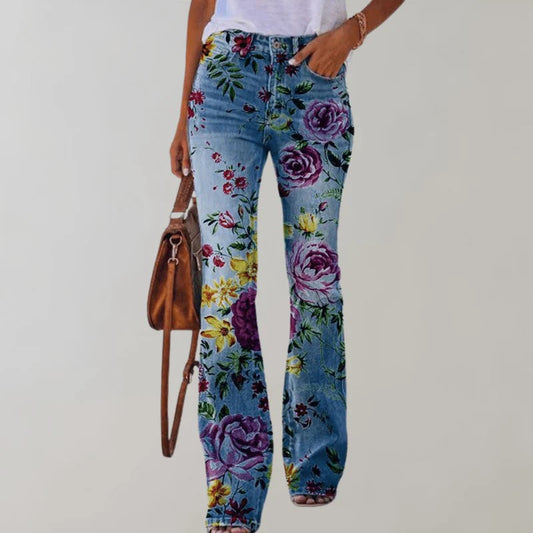 Frau in blauer Jeans mit buntem Blumenmuster, weißem T-Shirt und brauner Handtasche. Modetrend, Damenmode, florale Jeans.