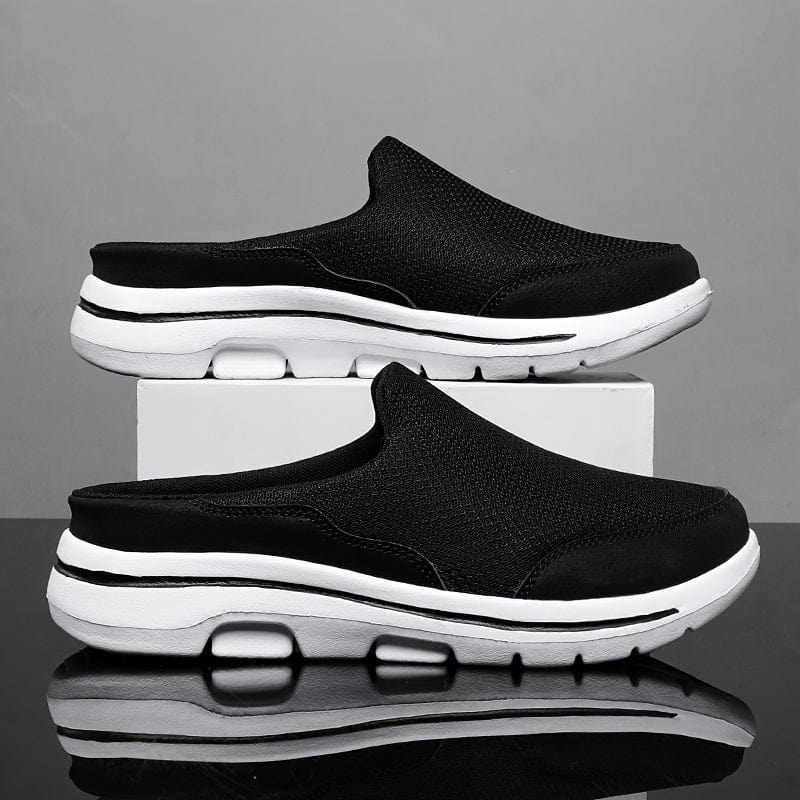 Schwarze Herren-Sneaker-Slipper mit weißer Sohle, atmungsaktives Mesh-Obermaterial, rutschfest, ideal für Freizeit und Sport.