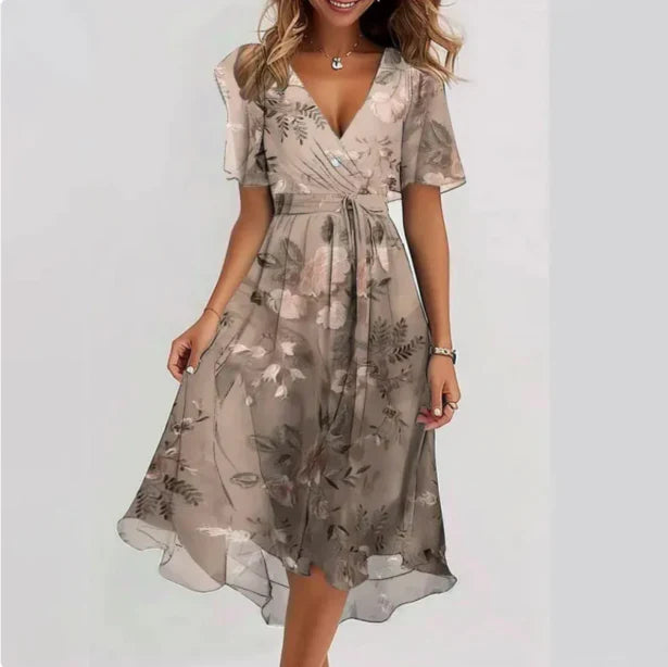 Frau in geblümtem Sommerkleid, V-Ausschnitt, knielang, fließender Stoff, elegantes Design, modische Damenbekleidung, Freizeitmode.