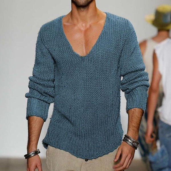 Mann trägt blauen Strickpullover mit V-Ausschnitt, kombiniert mit Armbändern. Modetrend, Herrenmode, lässiger Stil, Strickmode.